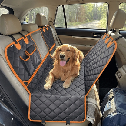 Dog riding in a car seat protected by the Furrwell Dog Car Seat Protector Mat in Orange Black